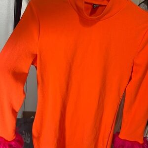 Orange fitted dress with pink fuzzy at the end